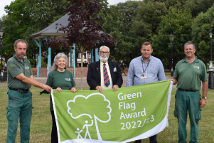 Staff, volunteers and Councillor Michael Talbot with the 2022 Green Flag in Cliff Park Dovercourt