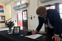 Councillor Peter Harris signs the Book of Condolence at Clacton Town Hall