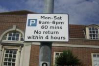 Parking restriction sign on a lamp post